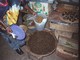 Market, Uganda.  Bucket of crickets and plate of ants